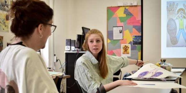 Student and teacher talking about art for children